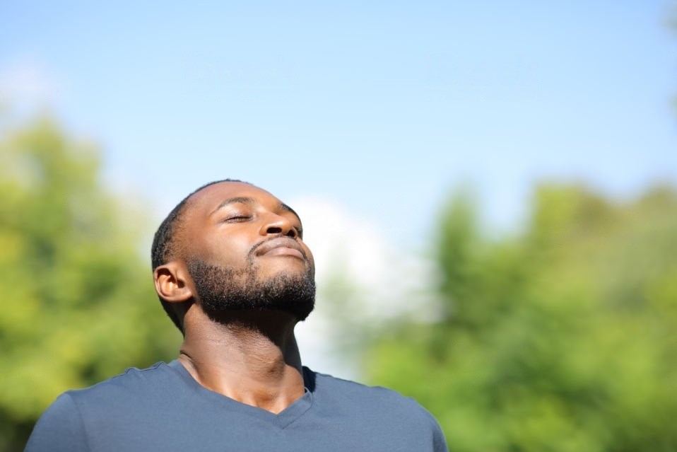 This image depicts a man practicing deep breathing as a coping skill.